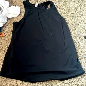 This is a black tank top with tinny breathable holes in the back.